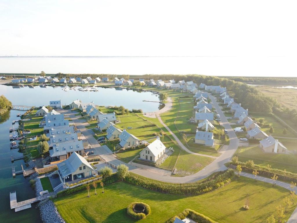 an aerial view of a resort on the water at Holiday Home Oesterdam Resort-1 in Tholen
