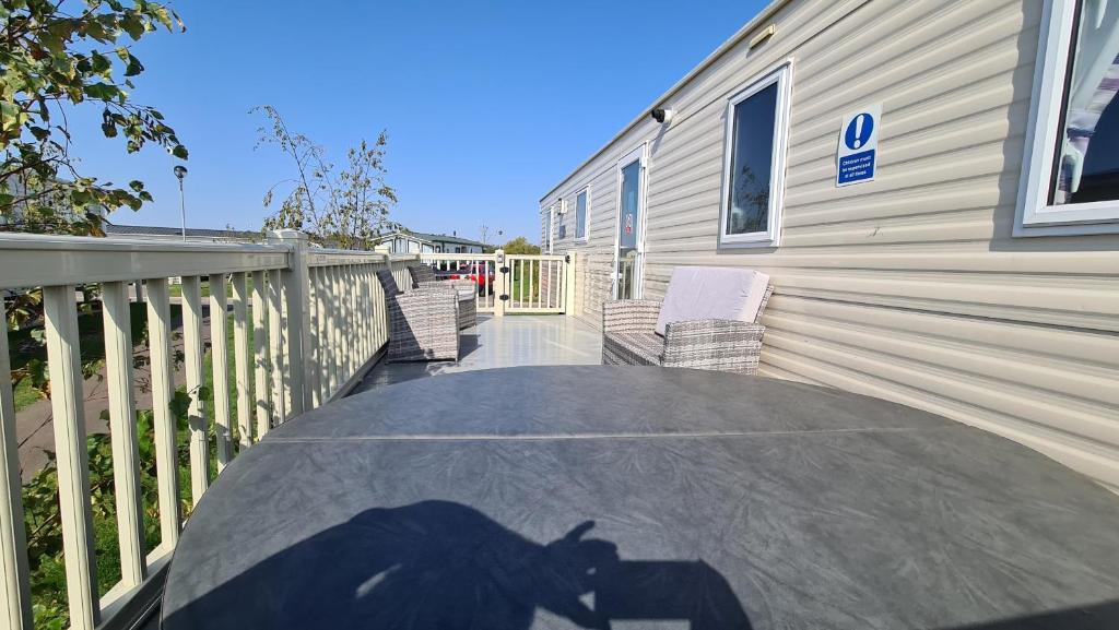 a shadow of a horse on a table next to a house at Luxury 2019 8 berth Caravan with Hot Tub @ Tattershall Lakes in Tattershall