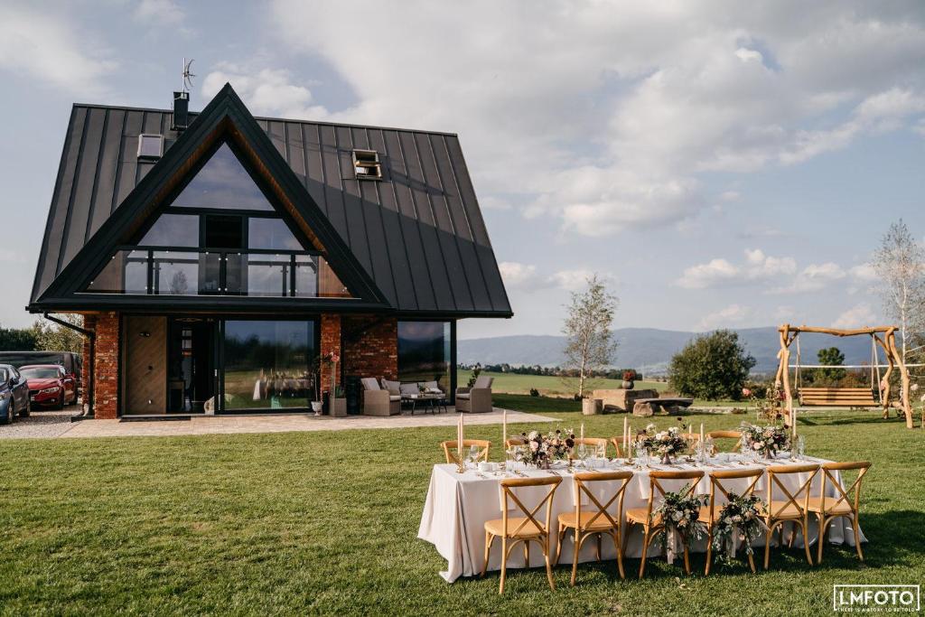 a table set up for a wedding in front of a barn at Białczańskie Bacówki in Białka Tatrzańska