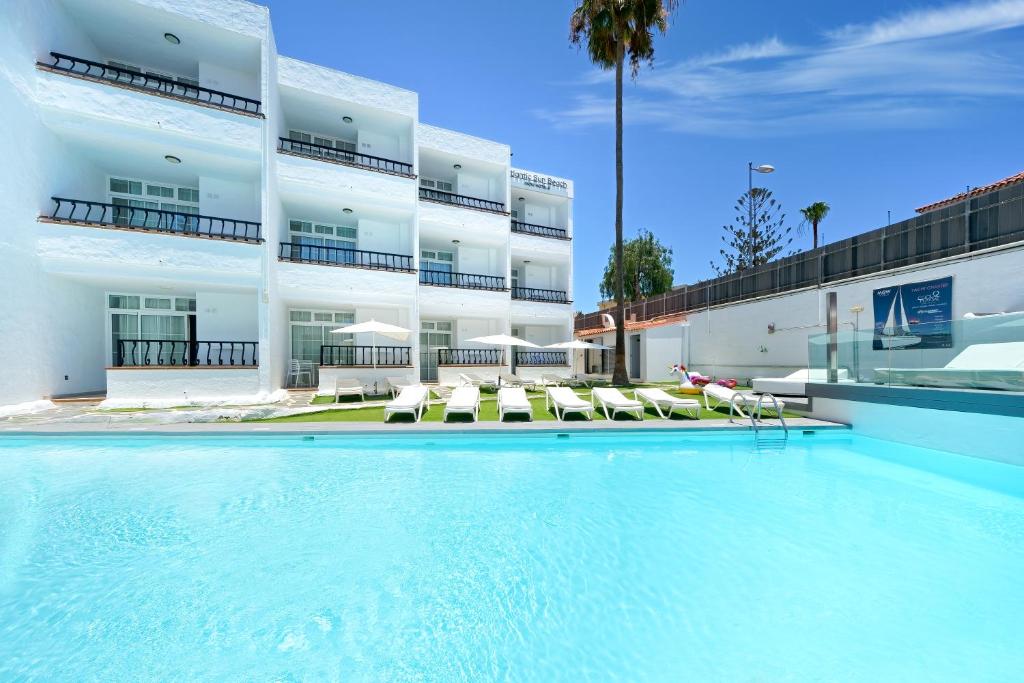 a swimming pool in front of a building at Atlantic Sun Beach - Gay Men Only in Playa del Ingles