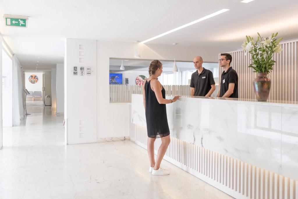 a group of people standing behind a counter in a room at Hotel Londres Estoril / Cascais in Estoril