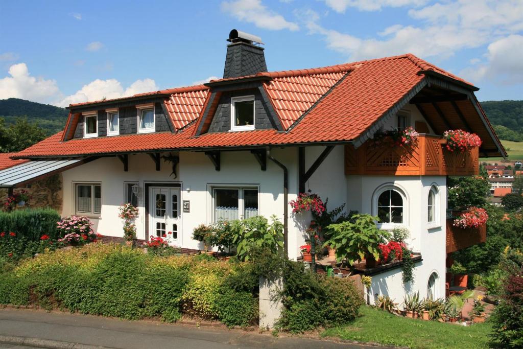 a white house with an orange roof at Haus Luise Weber in Hilders