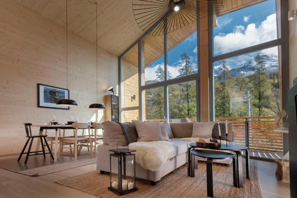 a living room with a white couch and a table at HelloChalet - Chalet Northern Lights - Family Ski Chalet with garden walking distance lift in Valtournenche