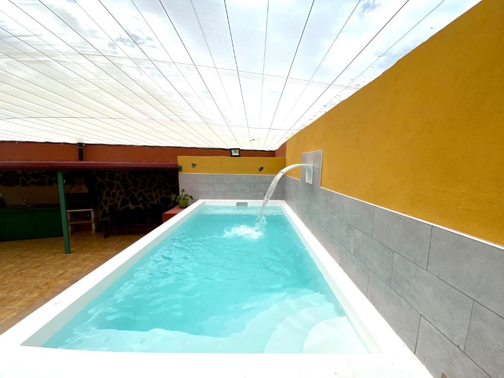 a large swimming pool with a water fountain at Casa Fagajesto in Las Palmas de Gran Canaria