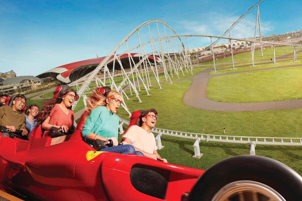 a group of people riding on a roller coaster at Yas Island Rotana Abu Dhabi in Abu Dhabi