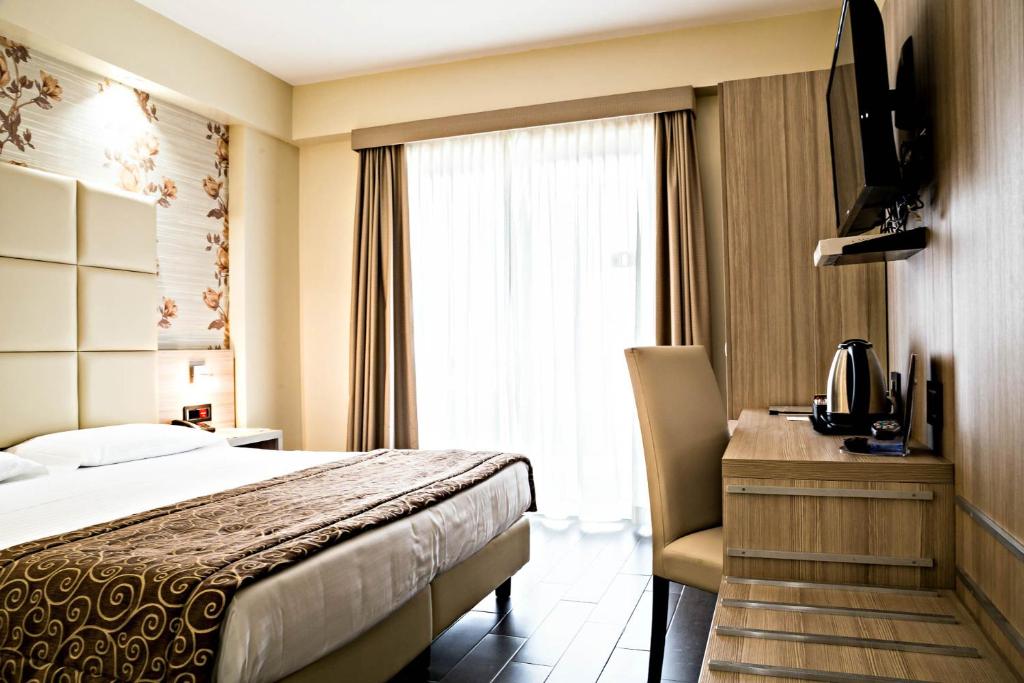 Postel nebo postele na pokoji v ubytování Hotel Pineta Palace