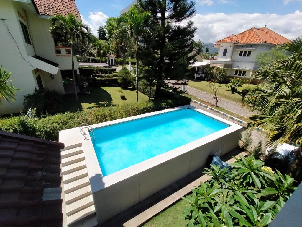 a swimming pool in the backyard of a house at Vila Batu Bale-Bale in Batu