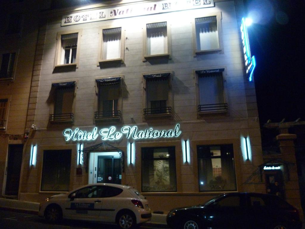 a building with a sign on the front of it at Hôtel Le National in Saint-Étienne