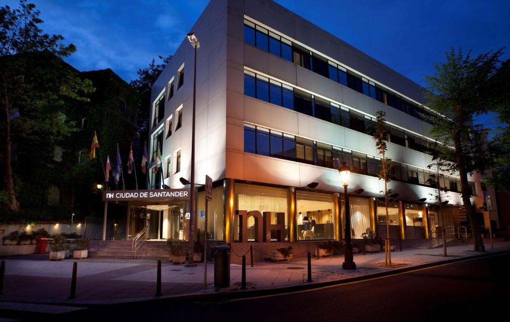 a building on a street at night at NH Ciudad de Santander in Santander