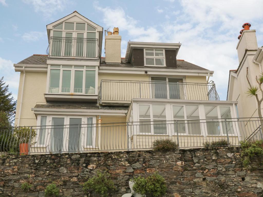 a large house on a stone wall at The Keel Row in Salcombe