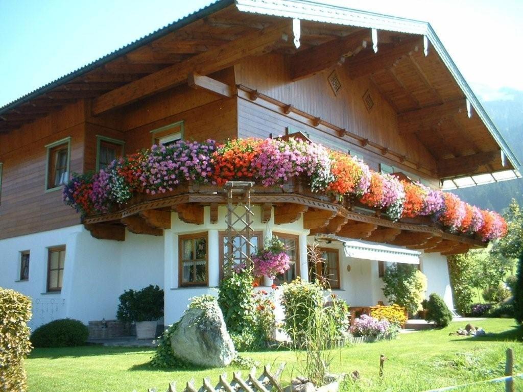 a house with a bunch of flowers on it at Appartement Christina in Westendorf