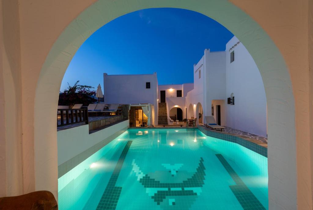 a swimming pool in a villa at night at Aella Residence in Naousa