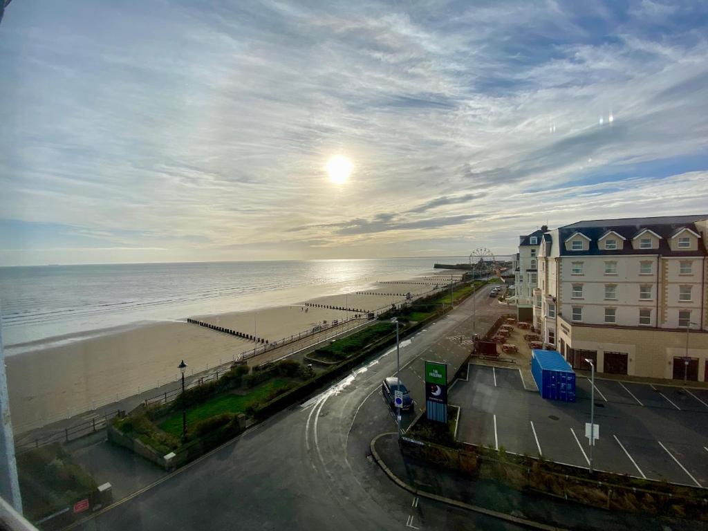 a view of a beach with the ocean and buildings at Oceana Holiday Apartments in Bridlington