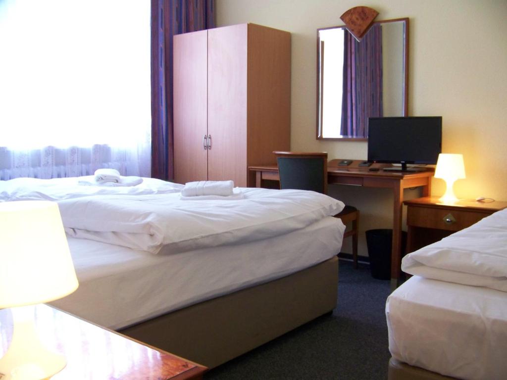 Postel nebo postele na pokoji v ubytování Hotel Amadeus Central
