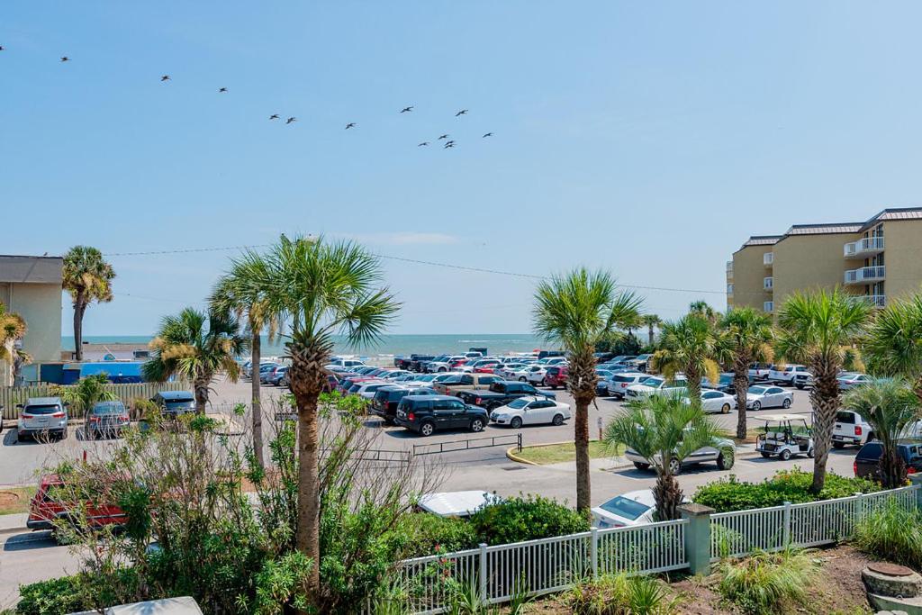 a parking lot with cars parked in a parking lot at 2B Pavilion Watch in Folly Beach