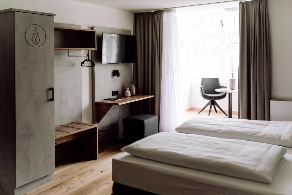 Amerang的住宿－DAS STEIN，一间卧室配有一张床、一张书桌和一个窗户。