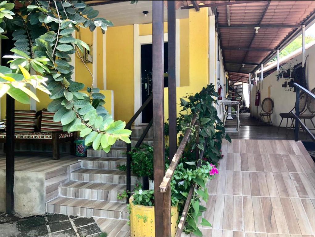 a hallway of a house with stairs and plants at Pousada Água Viva in Fernando de Noronha