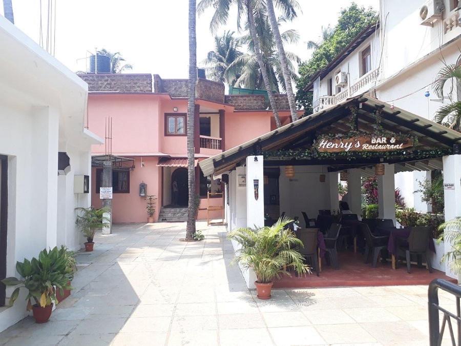 a restaurant with a patio with tables and chairs at Henry's Place in Calangute