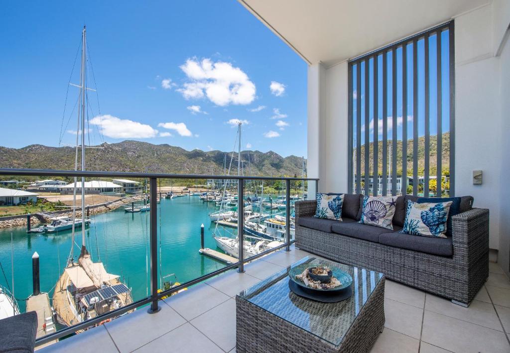 a living room with a view of a marina at Absolute Waterfront Magnetic Island in Nelly Bay