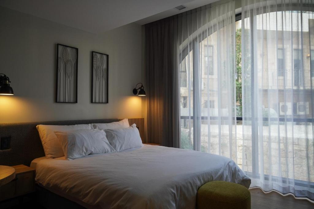 Postel nebo postele na pokoji v ubytování Apartique Hotel