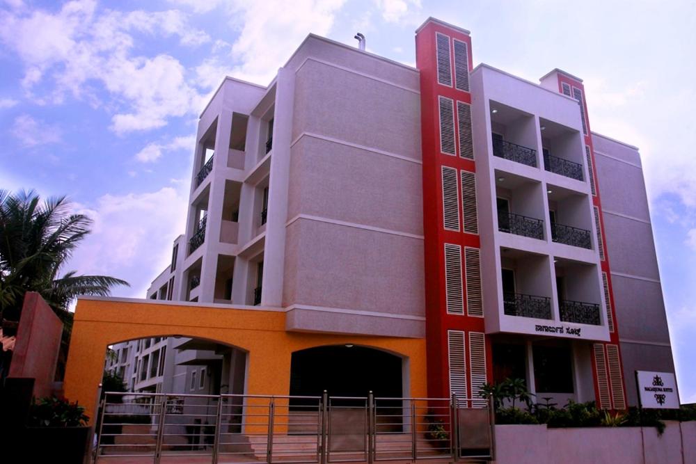 a building with an orange and white at Nagarjuna Suites in Bangalore