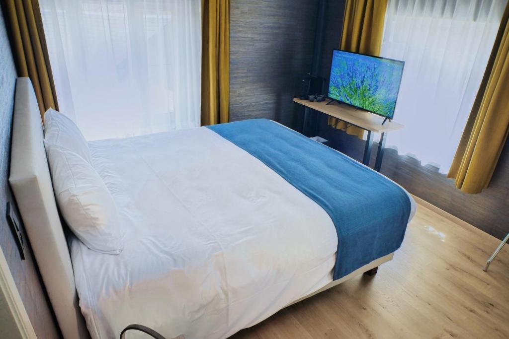 Postel nebo postele na pokoji v ubytování Hotel & Restaurant Maison Pal'Ange