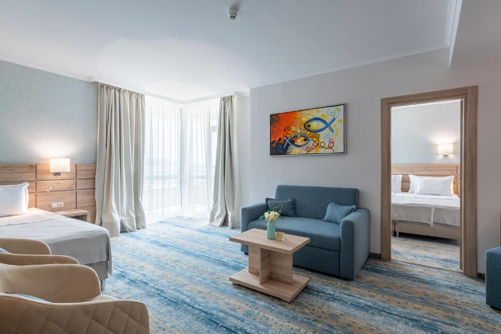Postel nebo postele na pokoji v ubytování Hotel Neptun Beach