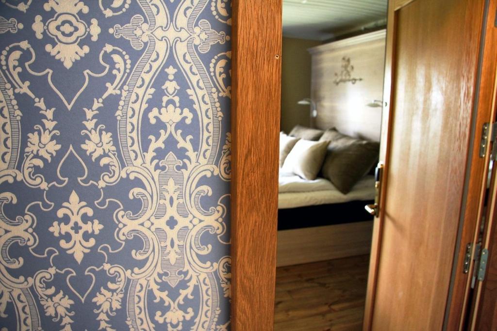 
A bed or beds in a room at Kongsvinger Castle Hotel & Resort
