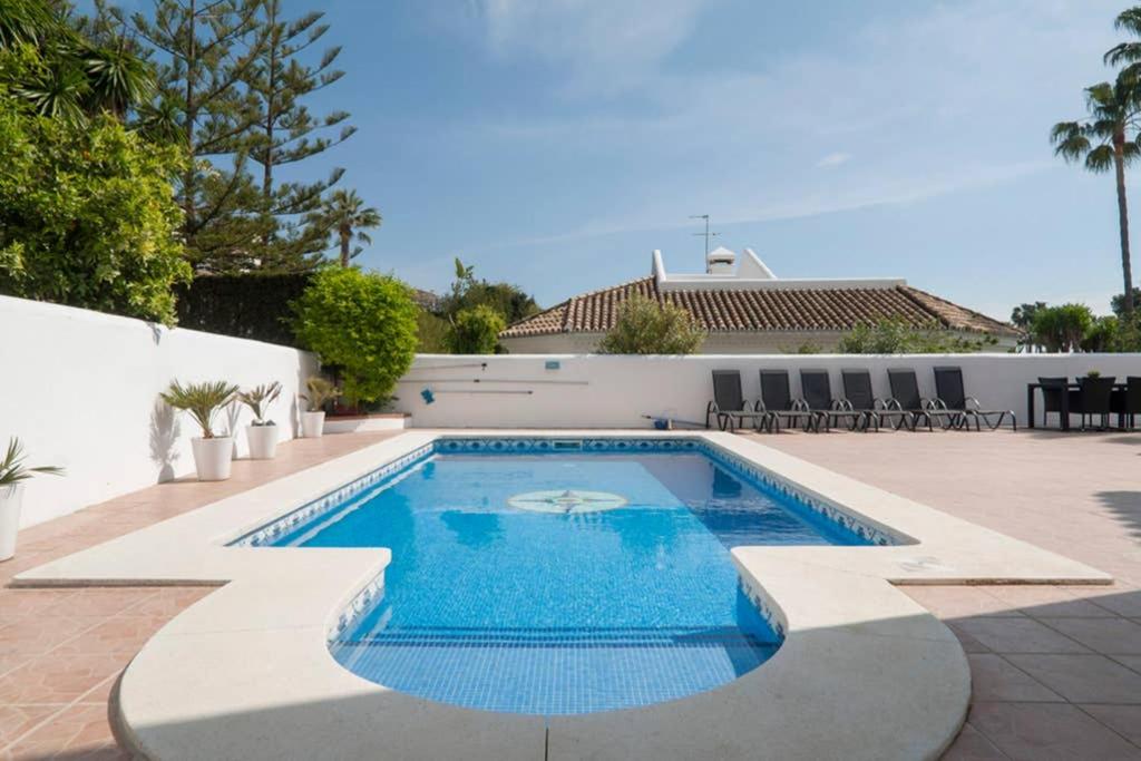a swimming pool in the middle of a patio at 049 - Modern & Spacious Holiday Villa With Private Pool in Fuengirola