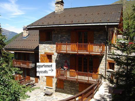 a large building with a balcony on the side of it at appartement myosotis pour 10 personnes in Saint-Martin-de-Belleville