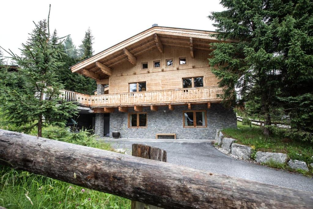 a large wooden house with a balcony on top of it at Chalet Hochkrimml 49 in Nothdorf