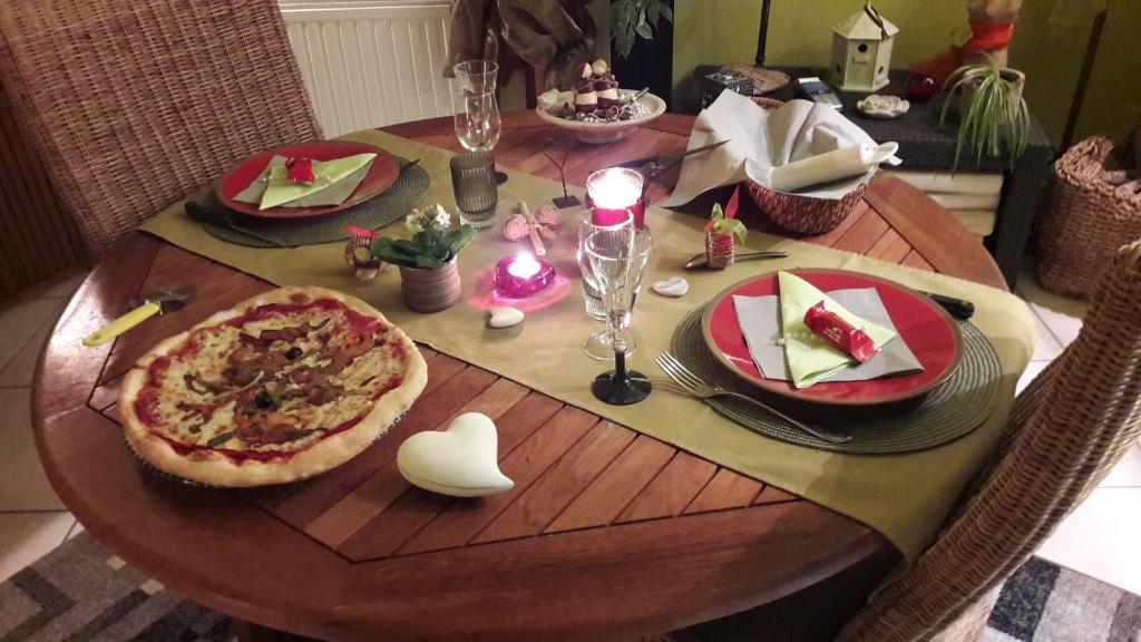 a wooden table with a pizza on top of it at B&amp;B Aquavert &amp; Wellness in Tournai