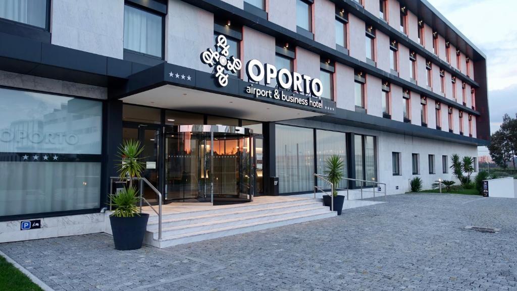 a building with a sign on the front of it at Oporto Airport & Business Hotel in Maia