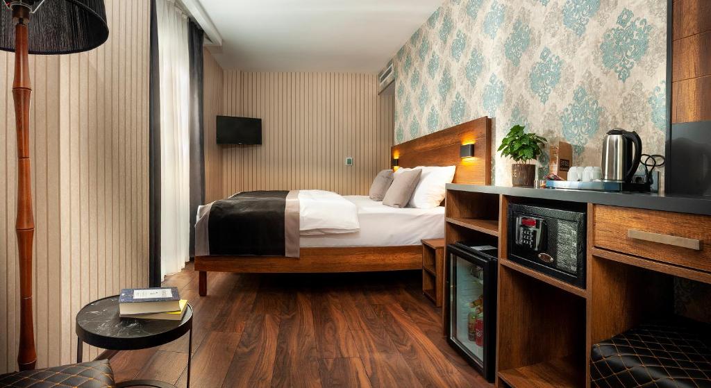 Кровать или кровати в номере Hotel Bossuite Business