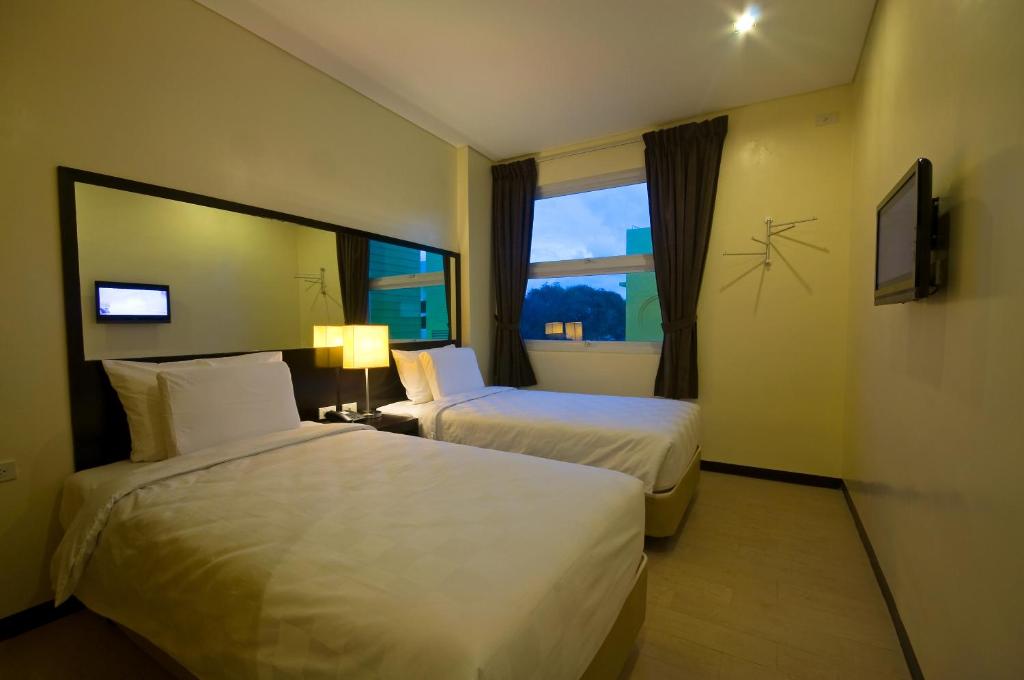 Postel nebo postele na pokoji v ubytování Go Hotels Iloilo
