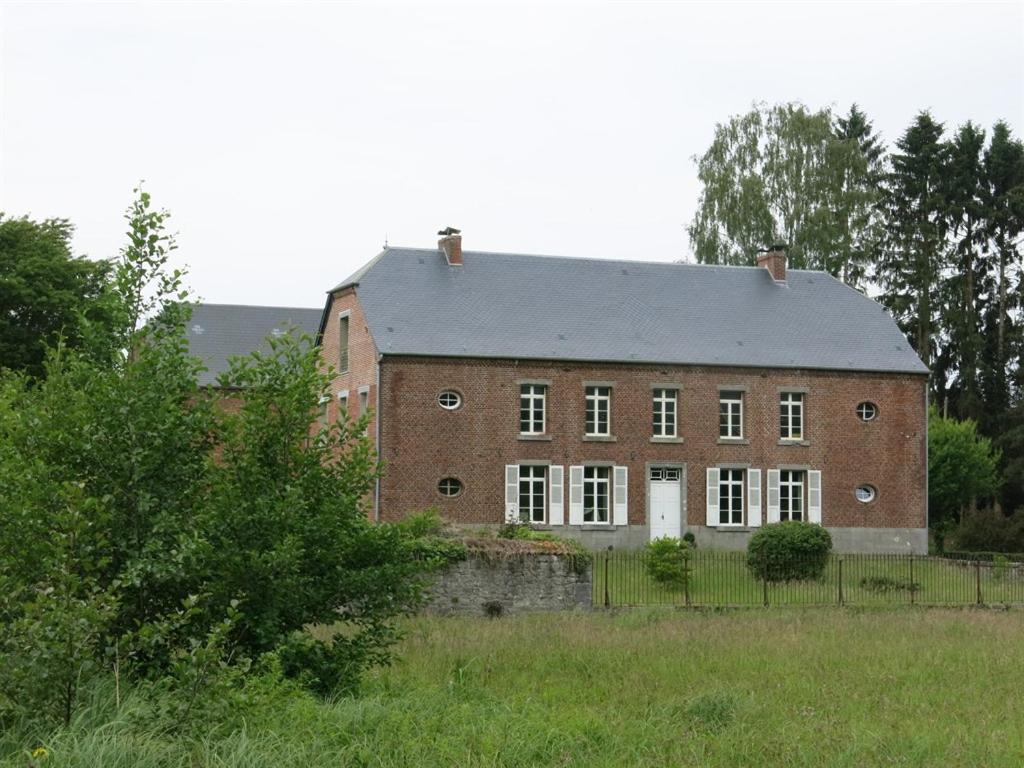 a large red brick building in the middle of a field at Maison d'Eclaibes in Éclaibes
