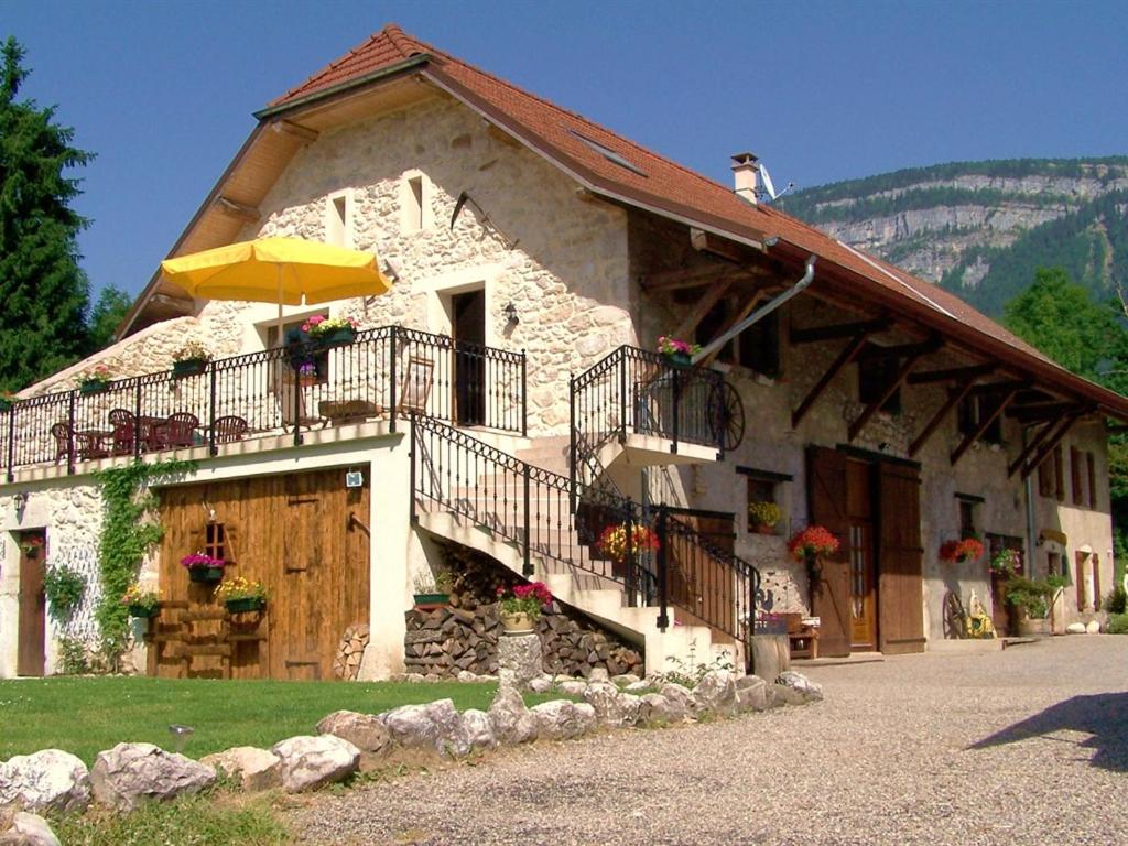 a building with an umbrella in front of it at Les Grands Champs in Attignat-Oncin