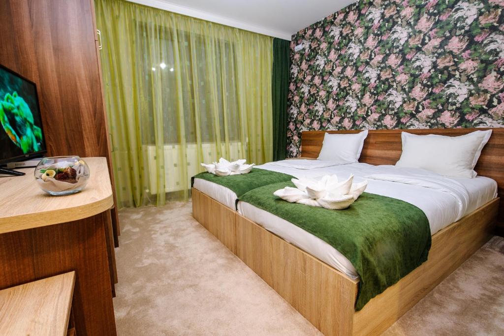 a bedroom with a bed with white flowers on it at Пиргуля in Miladinowzi