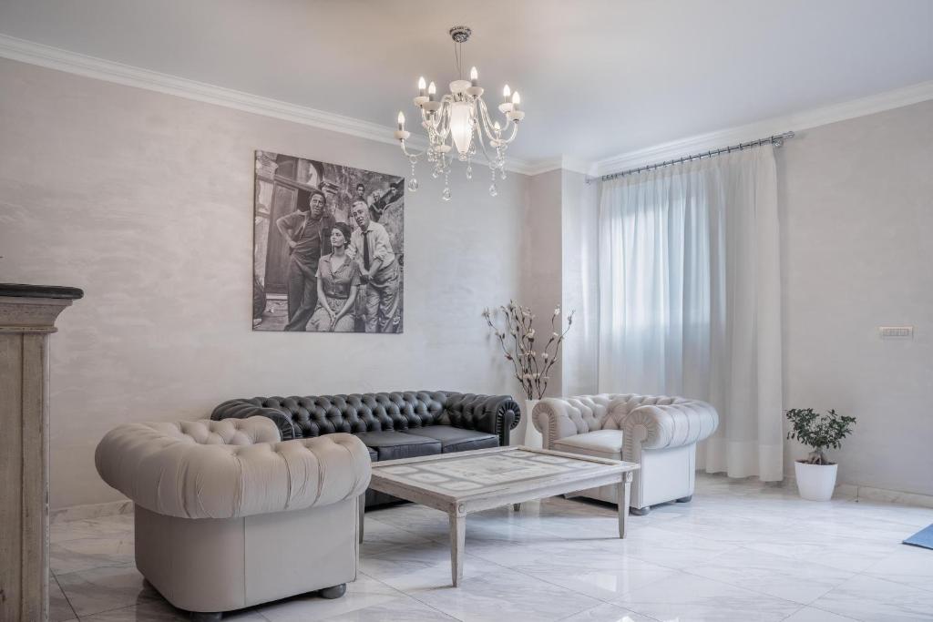 a living room with two couches and a table at Hotel Colomba D'Oro in Tropea