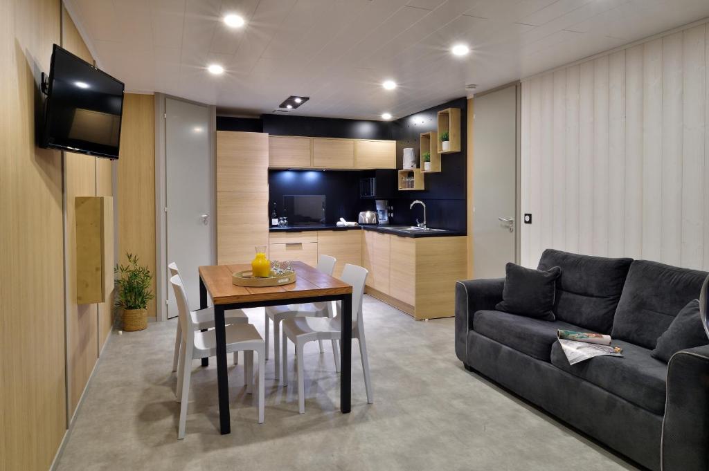 a living room with a table and a couch at Résidence & Hotel U Livanti ECOLABEL in Propriano