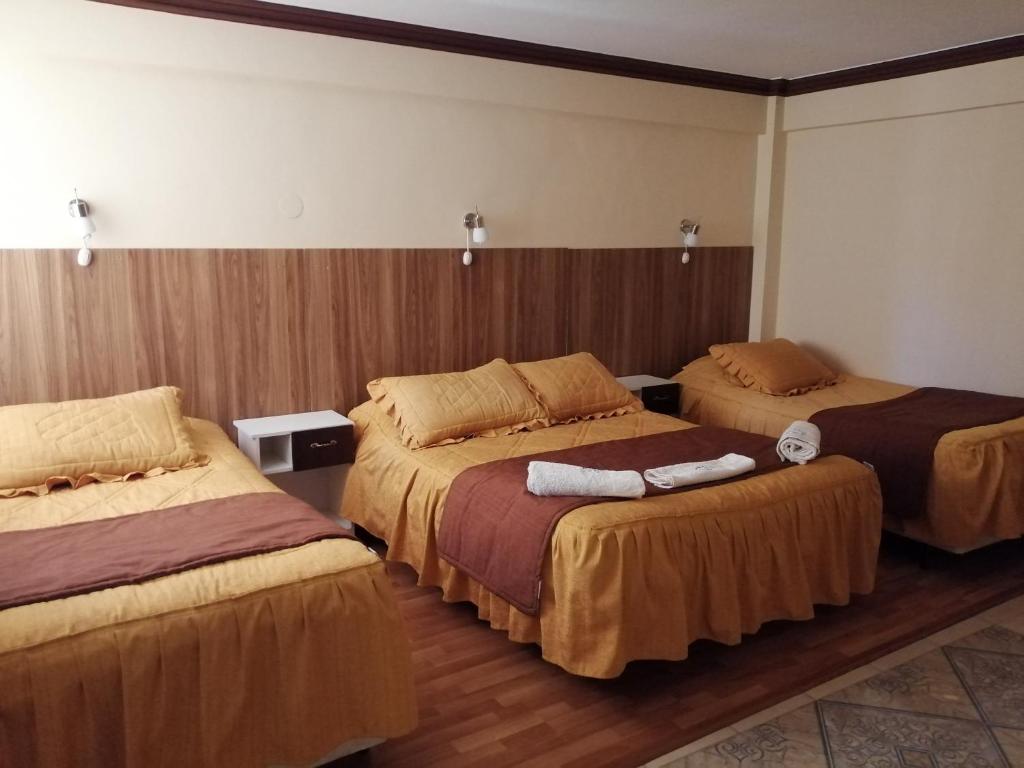 a hotel room with three beds in a room at Le Ciel d'Uyuni in Uyuni