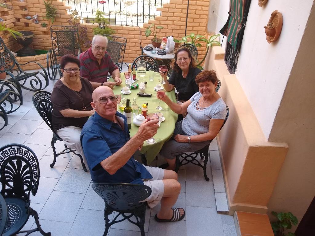 a group of people sitting around a table at Casa Colonial La Terraza in Havana