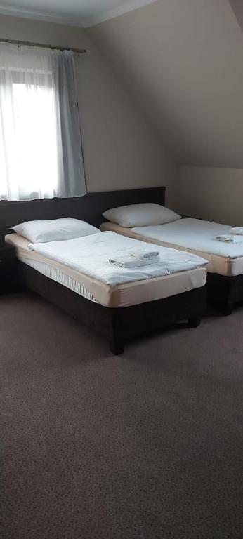 Postel nebo postele na pokoji v ubytování Gościniec nad Zalewem
