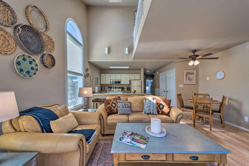 a living room with two couches and a table at Cloudcroft Townhome with Deck - 1 Mi to Burro Ave! in Cloudcroft