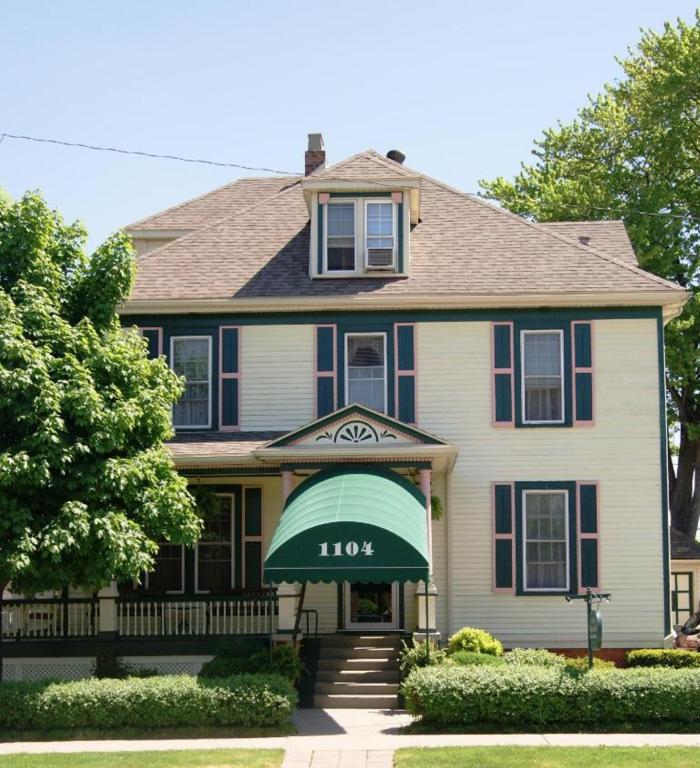 a house with a green awning in front of it at Ye Olde Walkerville Bed & Breakfast in Windsor