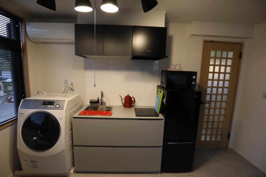 a kitchen with a washing machine and a washer at Saitama Kyodo Building - Vacation STAY 02388v in Saitama