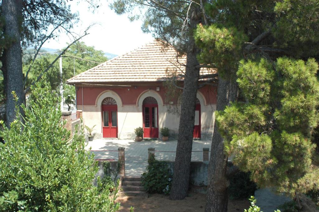 a small red and white house with red doors at B&B Sotto i Pini in Zafferana Etnea