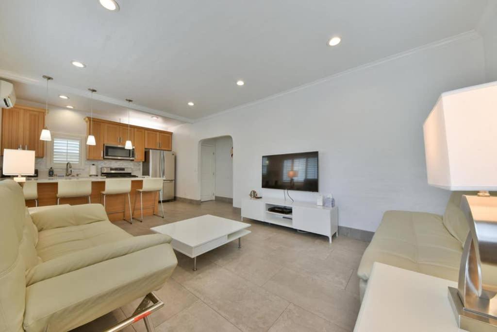 a living room with a couch and a table and a kitchen at 1000#1 Contemporary Home w/ Parking, Grill, & AC! in Newport Beach