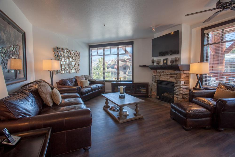 a living room with leather furniture and a fireplace at Village # 2230 - White Mountain Lodge in Mammoth Lakes