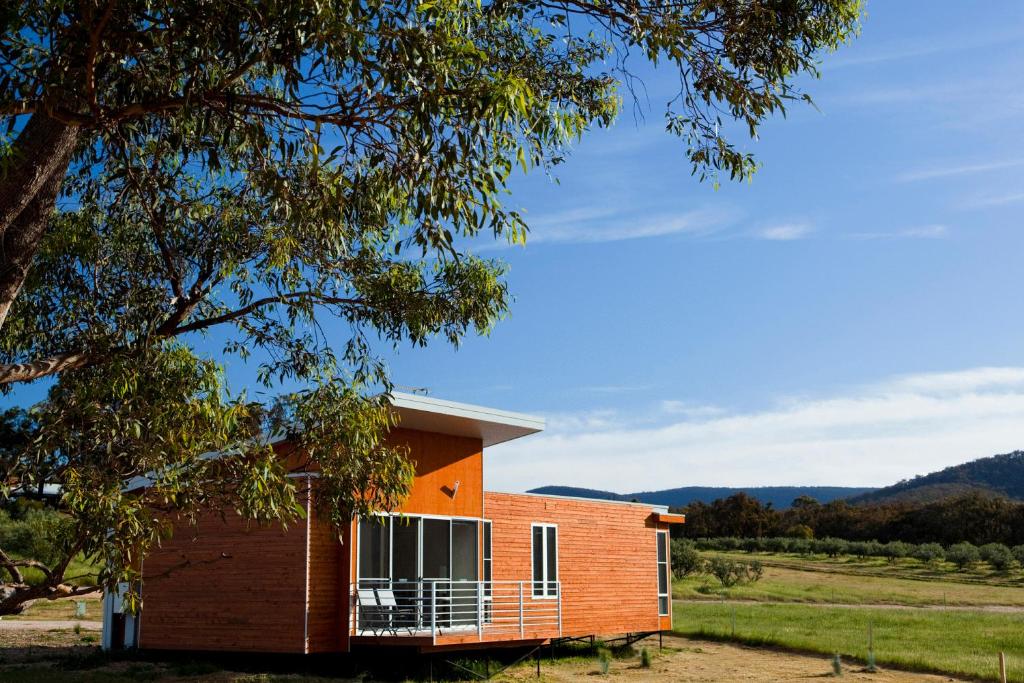 a house with a balcony on the side of it at Eco-Luxe @ Mount Avoca in Avoca